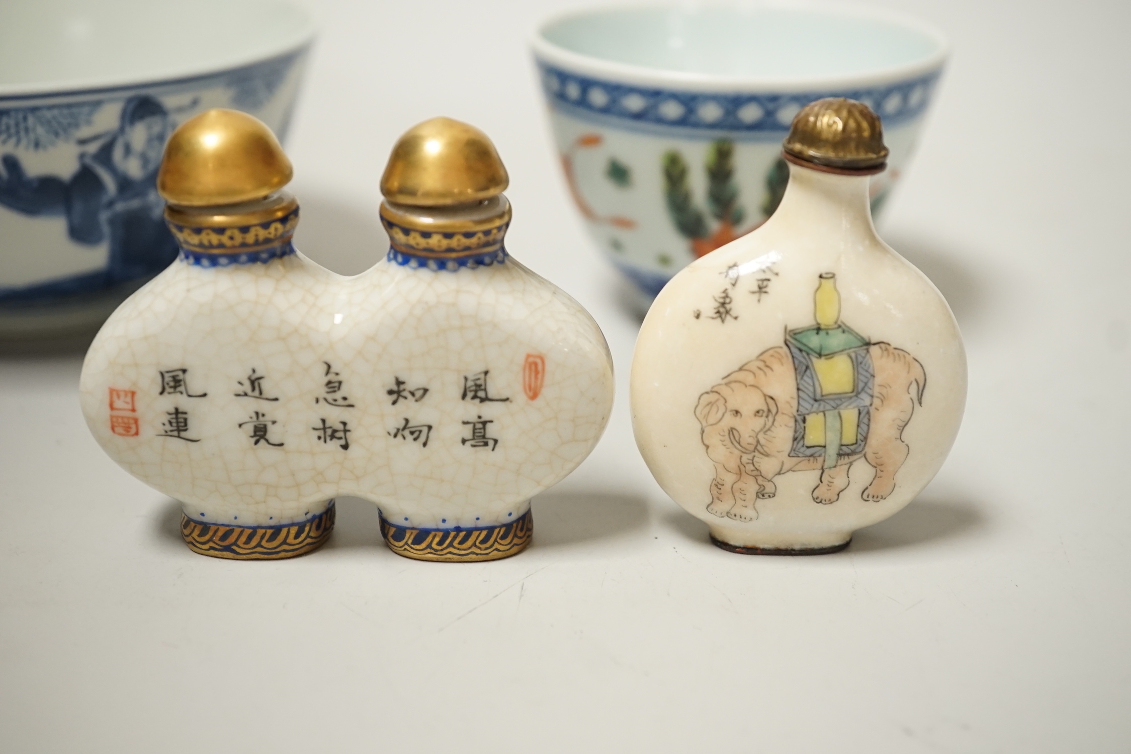 A 19th century Chinese blue and white bowl, an enamelled goldfish cup and two snuff bottles